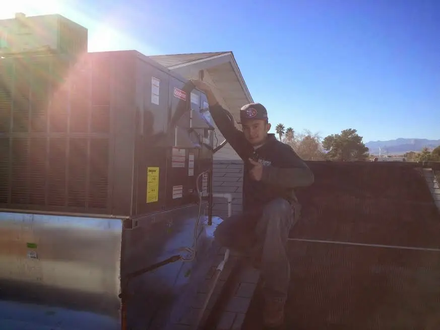 HVAC technician performing AC Tune-Up on a rooftop unit in San Anselmo